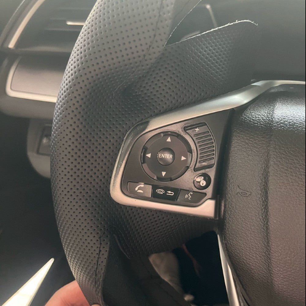 Close-up of hand-stitched seam and perforated leather on the Honda steering wheel cover