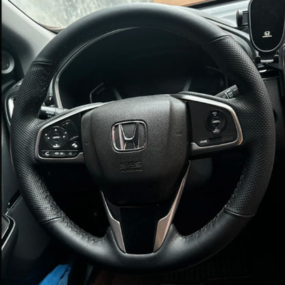 Black leather steering wheel cover fitted in a Honda CR-V interior