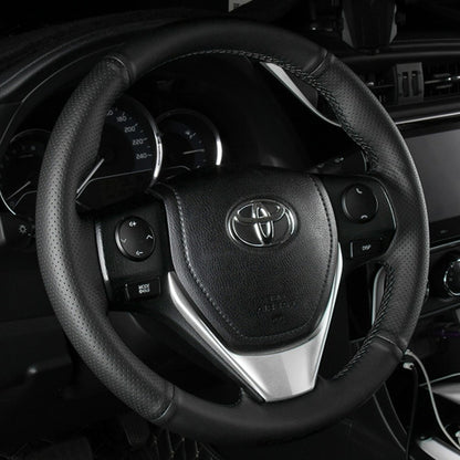 Black leather steering wheel cover fitted in a Toyota interior
