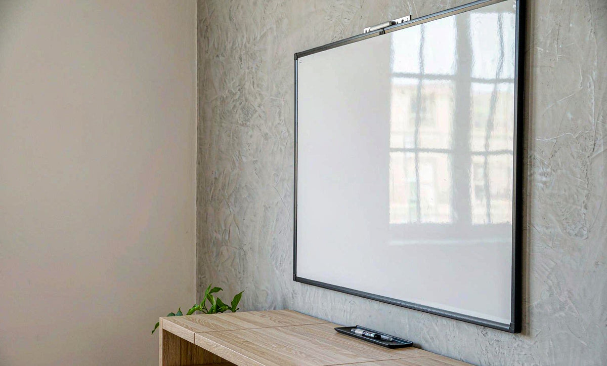 Minimalist office with glass whiteboard